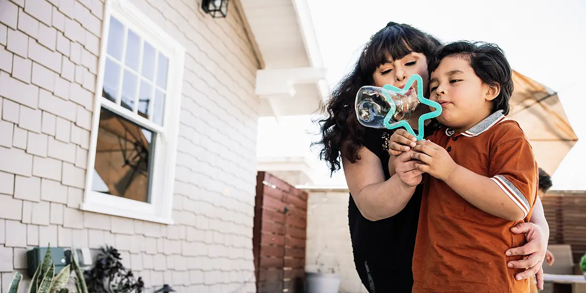 mom and son blowing bubbles